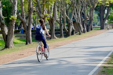 Traveller biking on the road for visit around Historic Town of Sukhothai and Associated Historic...