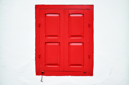 Classic wood red window on white wall backgroudの写真素材