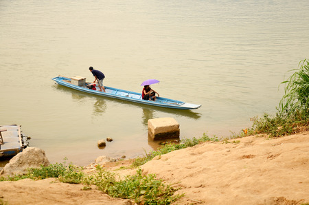 Laotian people rowing wooden boat at mekong river on April 8, 2016 in Luang Prabang, Laosのeditorial素材