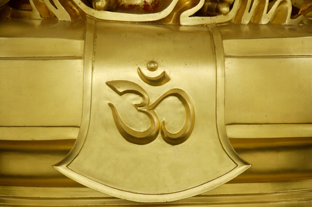 Gold word of hindu reading Om or Aum symbol in Devanagari is a sacred sound and a spiritual icon in Indian religions. It is also a mantra in Hinduism, Buddhism and Jainism.のeditorial素材