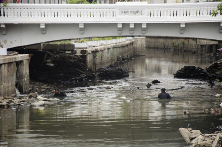 Trash keeper thai man collect garbage in underwater at wastewater and pollution water in canal for sale on June 28, 2016 in Bangkok, Thailandのeditorial素材