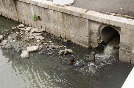 Trash keeper thai man collect garbage in underwater at wastewater and pollution water in canal for sale on June 28, 2016 in Bangkok, Thailandのeditorial素材