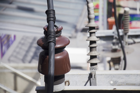 Insulator on electricity pillar or Utility pole at beside road in Bangkok, Thailandの写真素材
