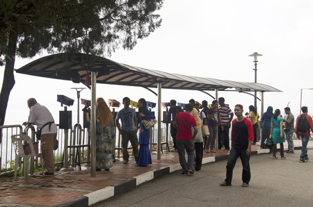 Traveller and Malaysian people travel and use binoculars looking penang city at bukit bendera on April 26, 2016 in Penang, Malaysia.のeditorial素材