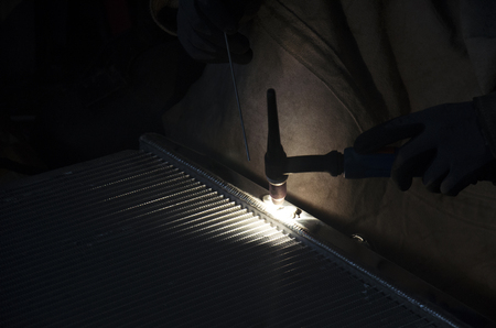 Thai people use electricity welding for fix and solder radiator of car at local garage in...