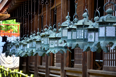 Many black steel lanterns hanging around at wooden church of Kasuga Shrine in Nara, Japanのeditorial素材