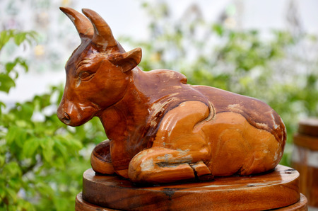 Traditional Thai style wood carving as animal wooden cow one of 12 Zodiac in church of temple in Thailand and this art decorated in created with money donated by people, no restrict in copy or useの写真素材
