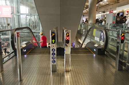 Thai people and foreigner traveller use escalators up and down floor at Suvarnabhumi international airport on December 11, 2016 in Bangkok, Thailandのeditorial素材