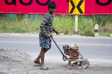 Thai people use soil compactors in construction site working and repair surface of road at rural roads countrysid on November 27, 2016 in Nonthaburi, Thailandのeditorial素材