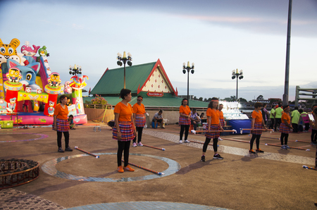 Older thai women group join activity exercise dancing with wooden long stick exercise for healthy in dusk time in Tha Nam Non on July 26, 2016 in Nonthaburi, Thailandのeditorial素材