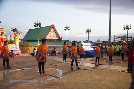 Older thai women group join activity exercise dancing with wooden long stick exercise for healthy in dusk time in Tha Nam Non on July 26, 2016 in Nonthaburi, Thailandのeditorial素材