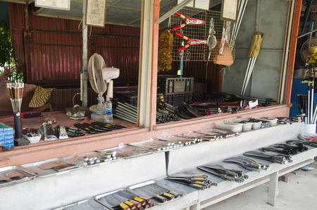 Asian thai people sale many kind of Aranyik knives on wooden shelf for travelers people at Store knives or Knife Shop on January 25, 2017 in Ang Thong, Thailandのeditorial素材