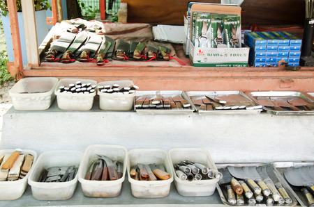 Asian thai people sale many kind of Aranyik knives on wooden shelf for travelers people at Store knives or Knife Shop on January 25, 2017 in Ang Thong, Thailandのeditorial素材