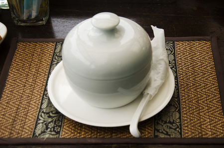Thai rice soup with pork in ceramic bowl serve for eating morning time at resortの写真素材