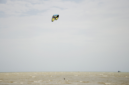 Thai people playing Kite Surf with wind and wave on the sea at Laem Charoen beach and Mae Pim beach in Rayong, Thailandの写真素材