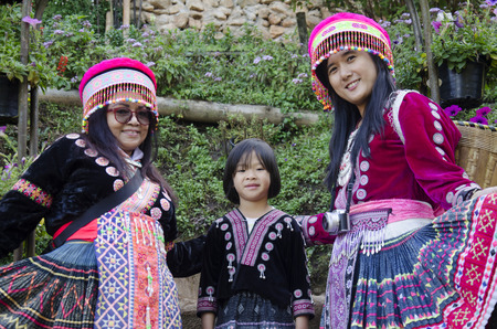 Thai women people wearing costume traditional of ethnic hmong for take photo with children at Doi Pui Tribal Village on December 28, 2016 in Chiang Mai, Thailand.のeditorial素材