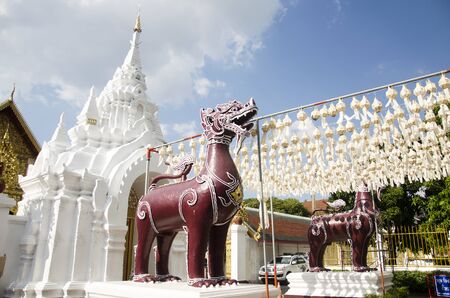 Singha or Lion guardian statues front of gate entrane for people walking go to praying and visit chedi at Wat Phra That Hariphunchai temple on December 28, 2016 in Lamphun, Thailand.のeditorial素材