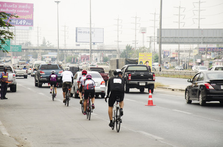 Asian thai people biking bicycle in race on street highway with traffic road at Bangbuathong city on February 26, 2017 in Nonthaburi, Thailandのeditorial素材
