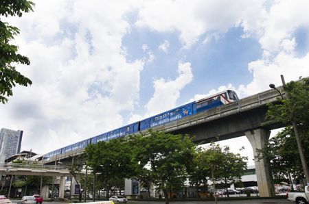 Cityscape and BTS or Skytrain running to stop at Mo Chit railway station with people walking and traffic at Chatuchak Market road on April 15, 2017 in Bangkok, Thailand.のeditorial素材