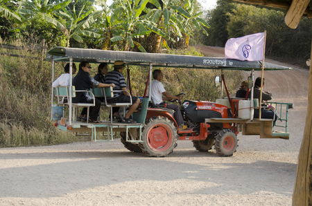 Thai people use tractor for service travelers tour Phu Pa Po mountain or Fuji City Loei on lateritic soil road go to at Phu Luang on February 22, 2017 in Loei, Thailandのeditorial素材