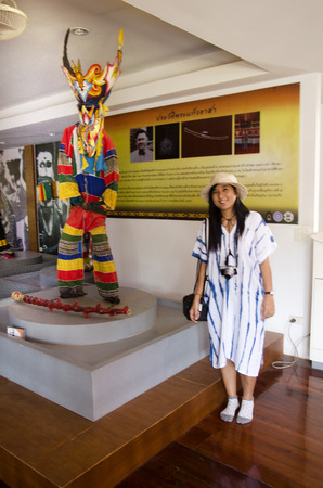 Asian thai woman travelers wearing mask head with costume of Phi Ta Khon dance and playing at Phi Ta Khon Museum in Wat Phon Chai on February 22, 2017 in Loei, Thailand.のeditorial素材