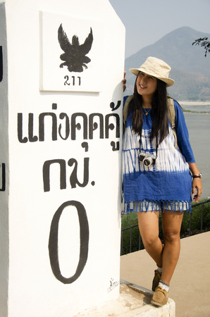 Travelers thai woman visit and posing for take photo with pole at viewpoint of Kaeng Khut Khu in Chiang Khan for writing blog on February 21, 2017 in Loei, Thailandのeditorial素材