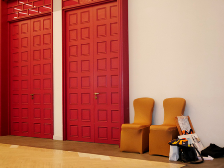 Red door old classic style on white wall background at inside hall of hotel in Bangkok, Thailand.のeditorial素材