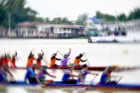 Blurred of motion of Thai people join match and competition in thailand traditional long boat racing festival at Chaopraya river in Nonthaburi, Thailandの写真素材