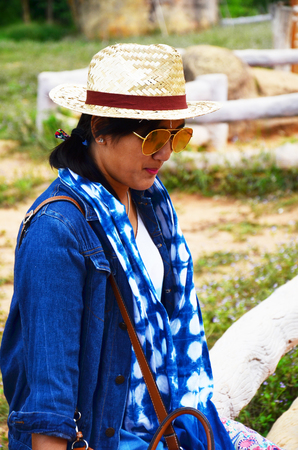 Thai women people travel and posing shooting photo with Mor Hin Khao or Thai Stonehenge in the Phu Laenkha National Park considered as a beautiful viewpoint located in Chaiyaphum , Thailandの写真素材