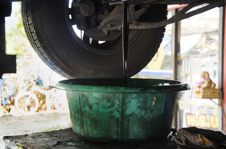 Thai mechanic professional motor repair and maintenance change oil and Check availability of car at local garage shop on December 19, 2016 in Nonthaburi, Thailandのeditorial素材
