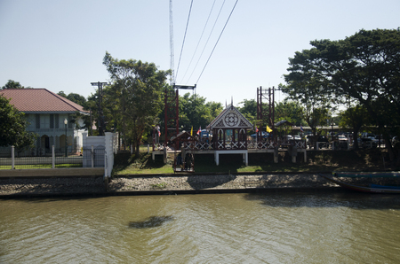 Asian people and foreign traveler use cable car across chao phraya river visit and pray Wat niwet thammaprawat gothic temple on December 19, 2016 in Ayutthaya, Thailandのeditorial素材