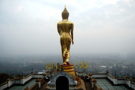 View point and buddha walking statue at Wat Phra That Khao Noi temple located on top of Khao Noi hill for people visit and travel  on February 11, 2012 in Nan, Thailandのeditorial素材