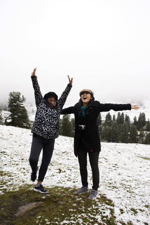 Asian thai people daughter and mother travel and posing for take photo with snow at top of mountain in Kaunergrat nature park while snowing in Tyrol, Austriaの写真素材