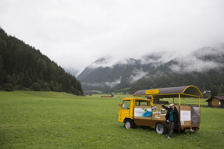 Asia thai women travel and posing with small truck at garden of hotel resort in Pfunds in morning time after rested on September 3, 2017 in Tyrol, Austriaのeditorial素材