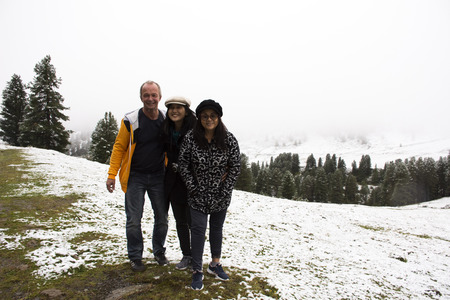 German and thai people travel and posing for take photo with snow at top of mountain in Kaunergrat nature park while snowing on September 3, 2017 in Tyrol, Austriaのeditorial素材