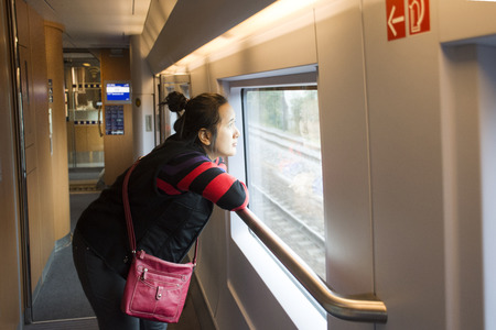 Asian thai women travelers walking visit and looking survey inside railway between train running from Paris, France go to Germanyのeditorial素材
