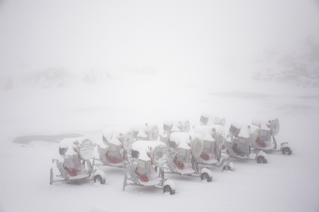 Snow Gun Snowmakers machine for ski resorts on ground parking at top of mountain in Kaunergrat nature park while snowing on September 3, 2017 in Tyrol, Austriaのeditorial素材