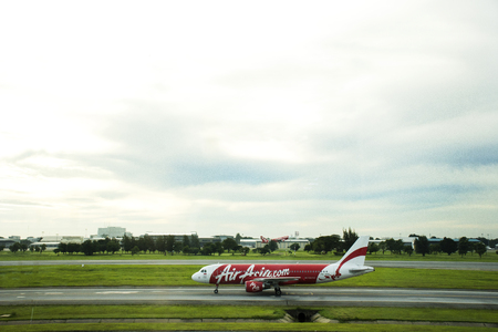 Aircraft prepare to take off from runway at Don Mueang international airport in dawn time on September 17, 2017 in Bangkok, Thailandのeditorial素材