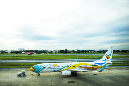 Aircraft prepare to take off from runway at Don Mueang international airport in dawn time on...