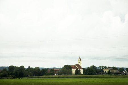 View landscape of mountain and grass field beside road at countryside between go to Tirol city in Austria passed at Ulm city in Stuttgart, Germanyの写真素材