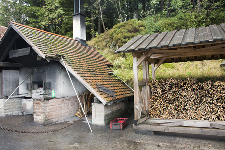 German people use firewood stove old style cooking bread at restaurant near Mummelsee lake in Black Forest or Schwarzwald on September 8, 2017 in Stuttgart, Germanyのeditorial素材