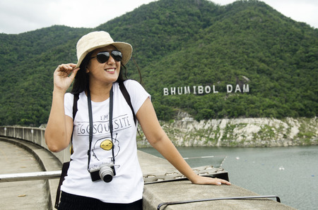 Asian thai women traveler visit at Bhumibol Dam and spillways formerly known as the Yanhee Dam on July 18, 2017 in Tak, Thailandのeditorial素材
