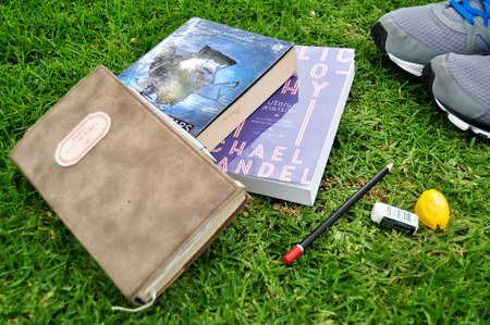 Thai people putting book and novel on the grass floors in garden at Kings Park and Botanic Gardens...