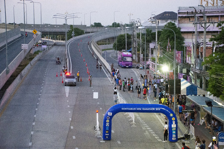 Thai men and women and foreigner people join charity event and running on the road in marathon race run in morning at urban on April 22, 2018 in Nonthaburi, Thailandのeditorial素材