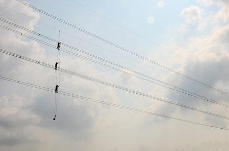 Electrician worker of Metropolitan Electricity Authority working repair electrical system on electricity pillar or Utility pole in countryside of Phra Nakhon Si Ayutthaya Province, Thailandのeditorial素材