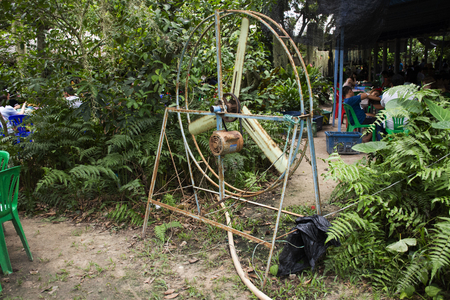 Old motor and big steel fan at outdoor for blowing cool down to travelers people in orchard garden  on May 29,2018 in Rayong, Thailandのeditorial素材