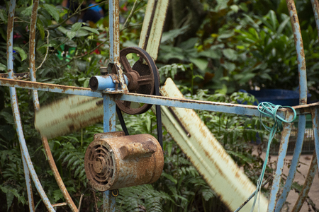 Old motor and big steel fan at outdoor for blowing cool down to travelers people in orchard garden on May 29,2018 in Rayong, Thailandのeditorial素材