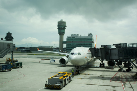 Traffic road and people working with airplane takeoff and landing on runway at Hong Kong Airport or Chek Lap Kok Airport on September 3, 2018 in Hong Kong, Chinaのeditorial素材