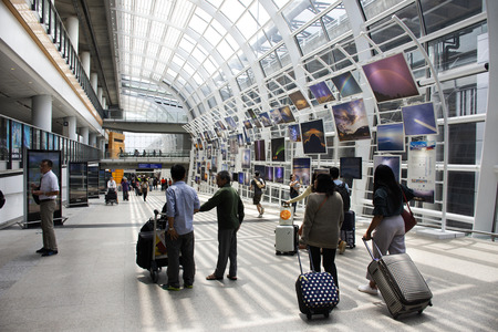 Chinese people and foreigners traveler walking in terminal of Hong Kong International Airport or Chek Lap Kok Airport on September 3, 2018 in Hong Kong, Mainland Chinaのeditorial素材