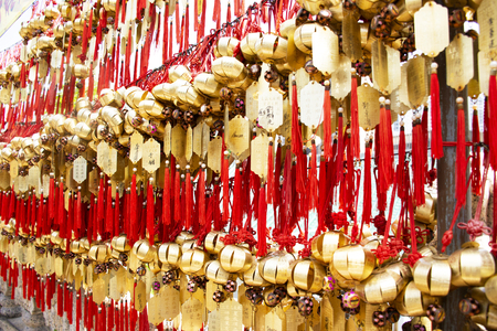 Chinese people and foreign travelers tied holy bell on wall for respect praying at Wong Tai Sin Temple at Kowloon island on September 9, 2018 in Hong Kong, Chinaのeditorial素材